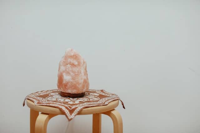 A Himalayan salt lap on a wooden chair.